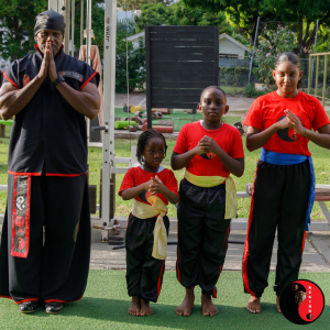 Grandmaster Bryan Campbell shows respect alongside students